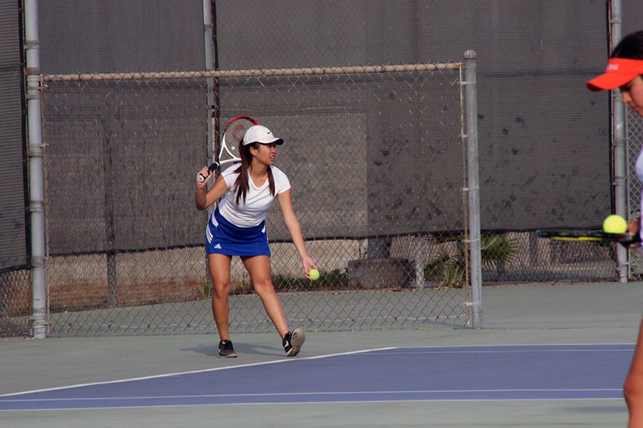 Monica Pangco prepares to serve.