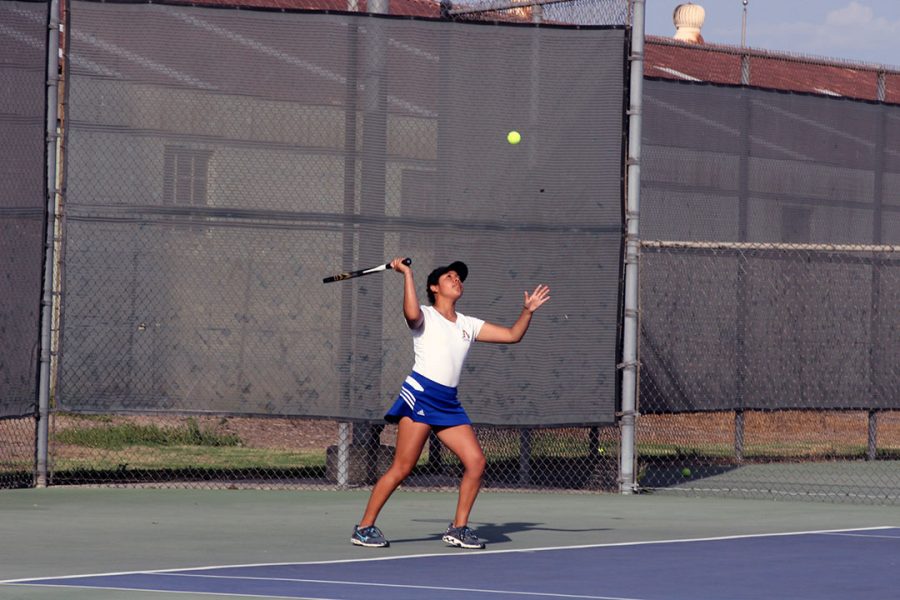 Maya Franco serves the ball.