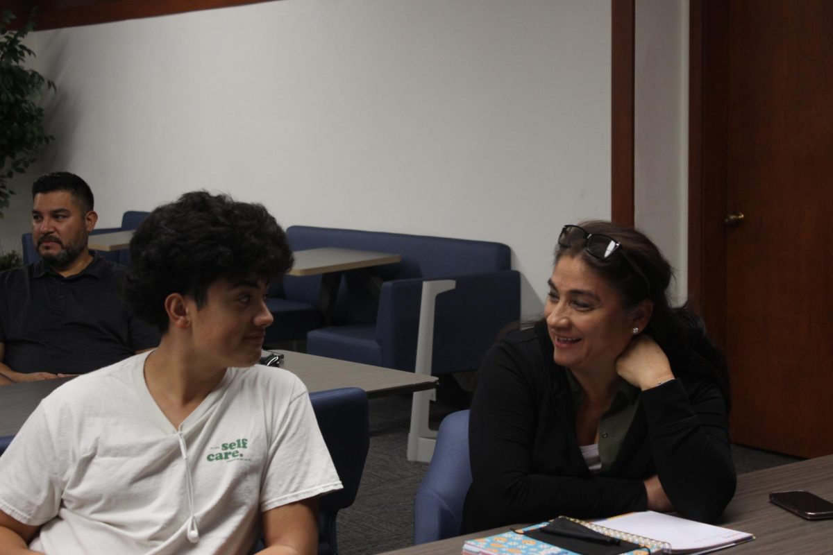 Student Dylan Matos listening to valuable advice from parent. Senior reflection night was a valuable time for both student and parent, gaining a closer bond with each other.